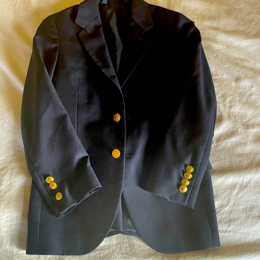 A small stain on the right collar. It is fully lined and an excellent condition.